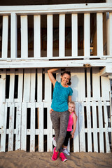 Portrait of healthy mother and baby girl on beach