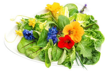Fresh green salad with edible garden flowers. Healthy food