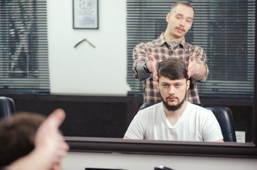 Barber discusses haircut with client