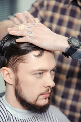 Fototapeta premium Man makes a haircut at barbershop