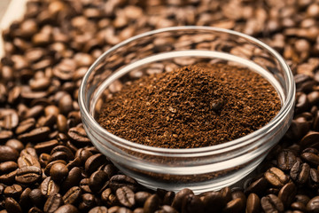 Natural ground coffee heap in transparent glass bowl