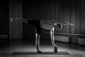 young man doing yoga in the gym, black and white 2