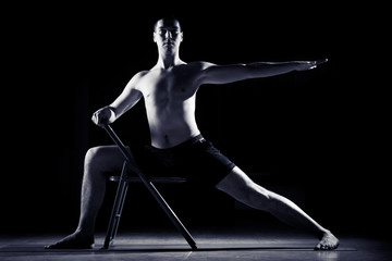 Obraz na płótnie Canvas young man doing yoga in the gym 2