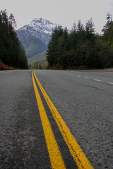 Lines on a roadway with a mountain in the background