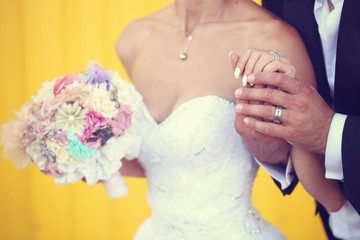 Bride and groom holding hands