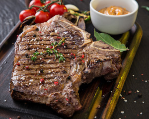 Beef t-bone steak on black stone table