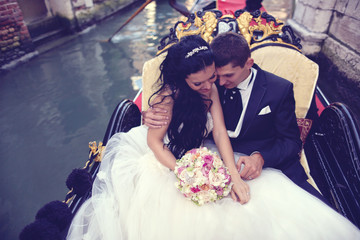 Bride and groom on a boat in Venice