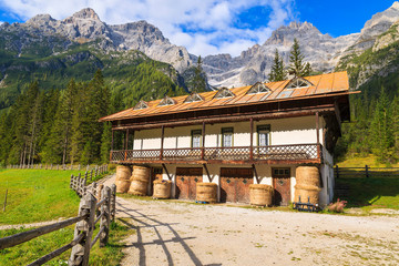 Fototapeta na wymiar Stable in green alpine valley in Dolomites Mountains, Italy