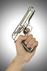 Naklejka premium Gun in the hand on white