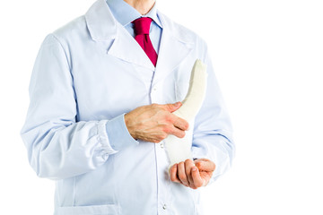 Doctor in white coat bandaging a banana