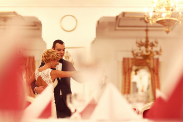 Elegant bride and groom dancing in wedding reception