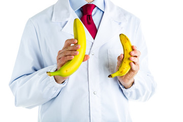 Doctor in white coat showing big and small bananas