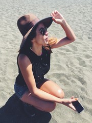 female with smartphone on beach