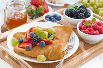 delicious breakfast - crepes with fresh berries and honey