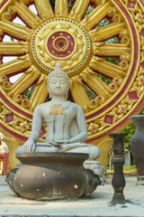 white sitting buddha stone carving under sunlight