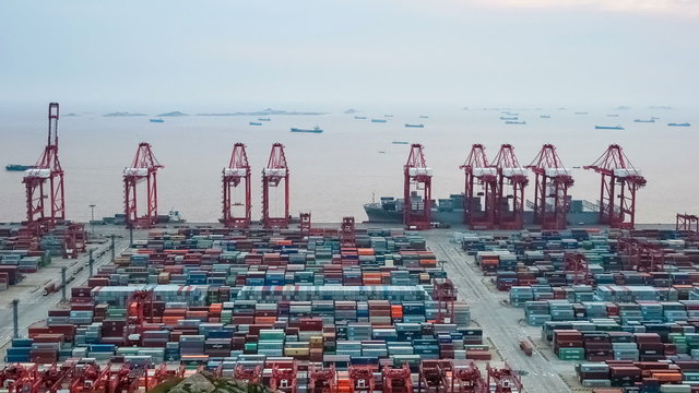 time lapse of busy container terminal in shanghai at dusk