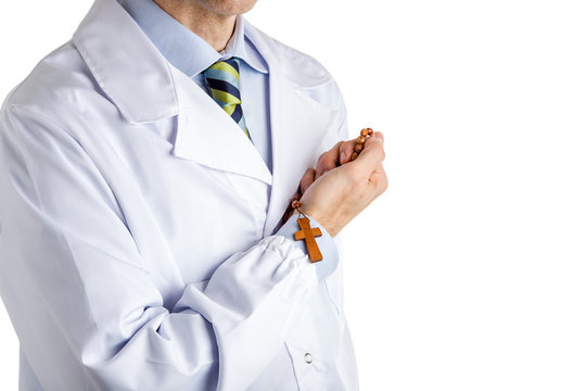 man in medical white coat holding wooden Rosary beads