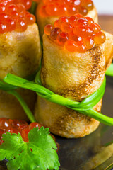 delicious pancakes rolled into rolls and caviar