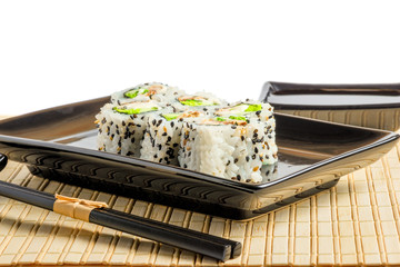 Traditional Japanese food is beautifully served in a black dishe