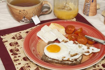 homemade breakfast, bread with butter, egg and cherry tomatoes