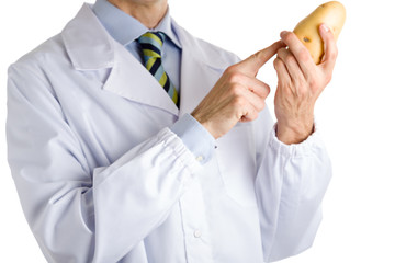 man in medical white coat showing potato