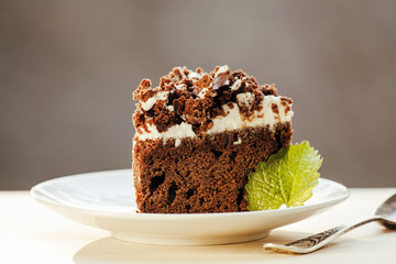 Delicious chocolate cake on plate on table