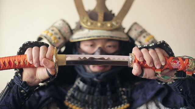 ancient Japanese samurai opens up his sword, close-up