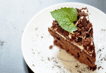 Delicious chocolate cake on plate on table