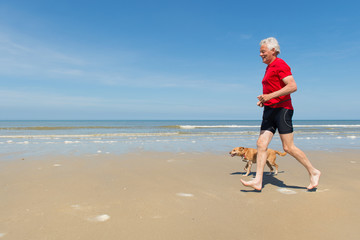 Running with dog at the beach