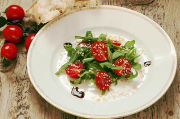 salad with tomatoes, arugula and sesame