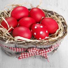 Fototapeta na wymiar Red Easter eggs in basket