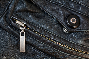 zipper and press stud in old black leather