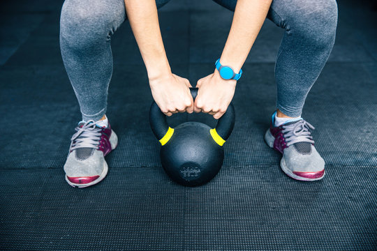 Woman working out with kettle ball