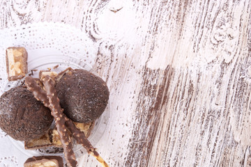 Cupcake with chocolate on wooden background
