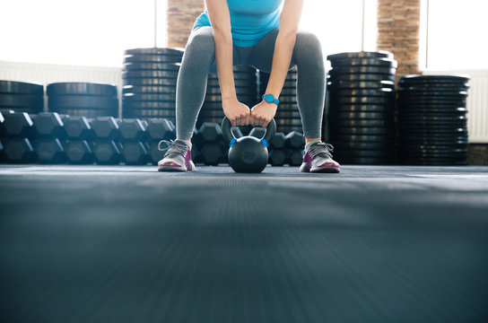 Woman working out with kettle ball