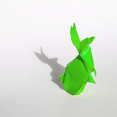 Green Origami rabbit isolated on white