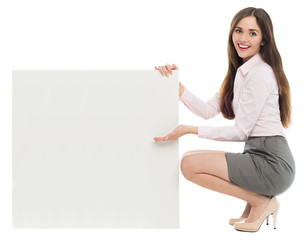 Woman crouching next to blank board