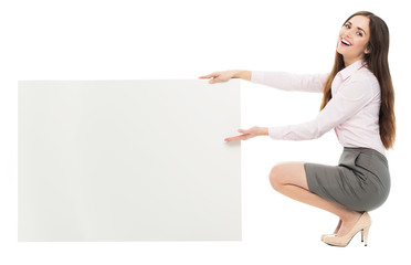 Woman crouching next to blank board