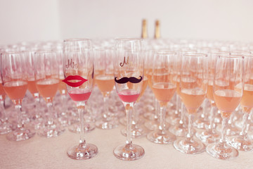 Glasses for bride and groom and guests filled with campagne