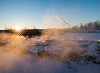 Winter landscape with factory chimneys