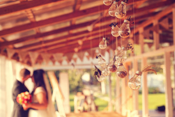 Bride and groom with light bulbs hanging