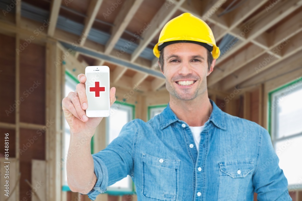 Poster Composite image of happy carpenter showing smart phone