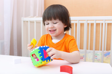 Lovely smiling child with educational toy