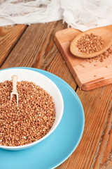 Buckwheat in a bowl on a wooden table