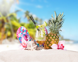 Mojito drink, Hat and flip-flops with tropical beach background,
