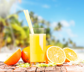  Orange juice on wooden with tropical beach 