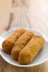 meat croquete on white dish