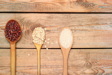 Grains in a spoon on a wooden table