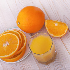 Orange juice with sliced orange half on wooden table