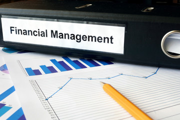Graphs and file folder with label Financial Management.
